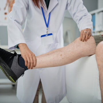 Physiotherapist Palpating Leg